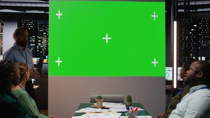 Chief financial officer presenting a projection on copy space mockup during late meeting after hours, discussing new strategy ideas to build a fruitful vision with shareholders. Camera A.