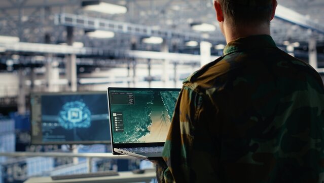 Military engineer in data center tracking satellite coordinates using laptop interface. Soldier in server room analyzing reconnaissance data through satellite imaging systems, camera B - Powered by Adobe
