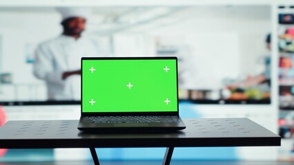 Chroma key notebook and video wall stacked with diverse entertainment media channels. Isolated screen laptop in front of digital backdrop displaying social networks feed activity