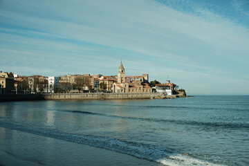 San Pedro church view in Gijon, Asturias, Northern Spain with a calm sea surface