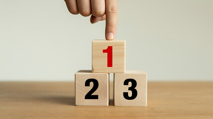 Hand Pointing to Number One Wooden Block - Priority, Success, or First Step Concept