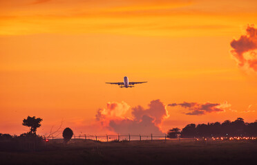 Jet Airliner Ascending into Fiery Sunset Sky