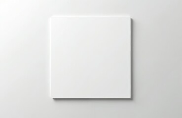 Square blank canvas with white painted wall. Art background for creative design. Top view picture with empty surface. Space for text and image. Neutral backdrop with light shadow for presentation.