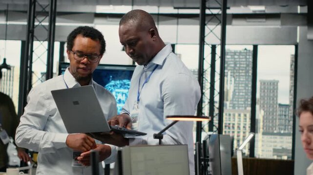 Team of technicians in office doing software development to launch new features. Startup coworkers writing computer programs, doing code testing and quality assurance, camera B