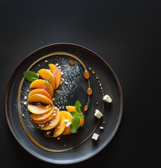 Detailed top-view image showcases a vibrant peach salad with spiraled slices, crumbled feta, and fresh mint. Honey drizzles add shine and sweetness. A refined summer dish with rich texture