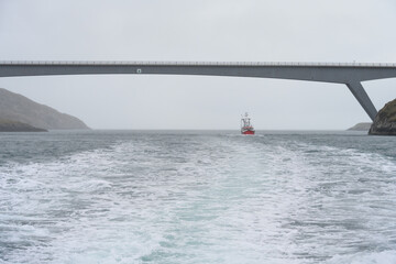 Red commercial fishing vessel off the coast of the Isle of Harris, Outer Hebrides, Scotland, UK
