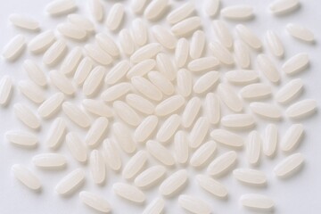 Pile of rice grains on white background, healthy eating and staple food concept