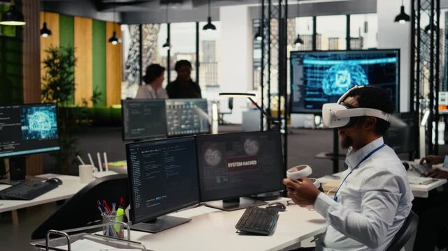 Programmer in office using virtual reality tech to fix hacking attempt on corporate network. IT expert uses VR headset to investigate unauthorized access alerts, working to mitigate damages, camera A