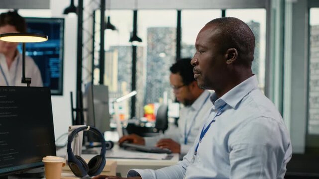 Data scientists doing brainstorming in office, using specialized hardware to accelerate complex AI calculations. IT professionals collaborating, managing deep learning datasets systems, camera B