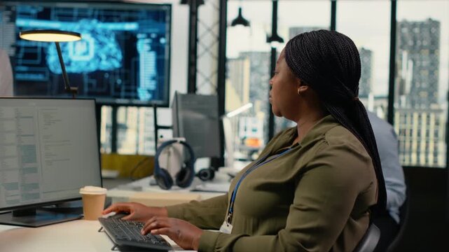 Multiethnic technicians in startup office work with artificial intelligence driving market innovation. Teamworking tech agency colleagues apply machine learning to optimize operations, camera B