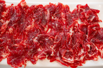 top view dish of raw hanger steak slices at horizontal composition