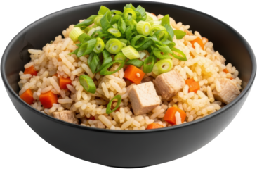 A black bowl of savory fried rice with diced chicken bright orange carrots and fresh green scallions presented on a transparent background green onions