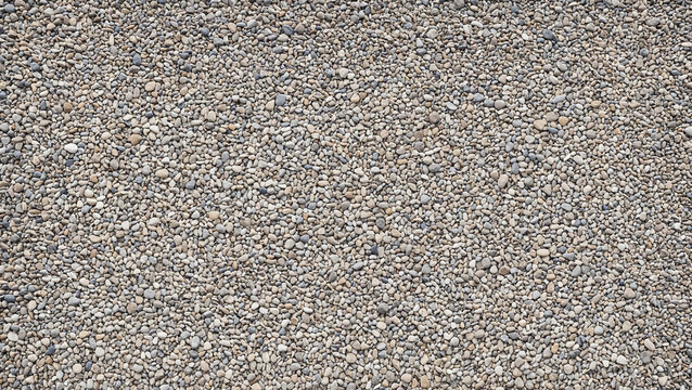 texture of small grey gravel stones or pebbles covering the ground