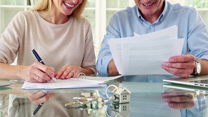 house keychain, signing mortgage, couple buying property, financial agreement, real estate | real estate, finance, homeownership, property, investment theme