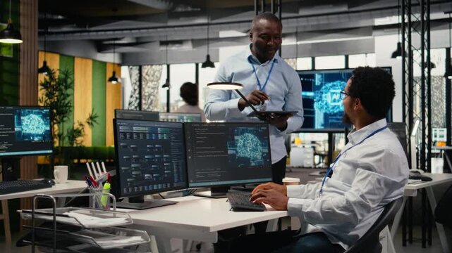 Smiling programmers working in AI startup train predictive models for language processing tasks. Cheerful IT professionals use machine learning technical expertise for complex tasks, camera A