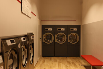 modern, well-equipped laundry room designed for shared use in a residential or commercial building