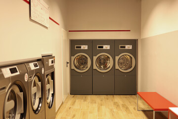 modern, well-equipped laundry room designed for shared use in a residential or commercial building