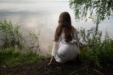 Contemplation by the Water: Woman in White Dress Gazing at the Lake
