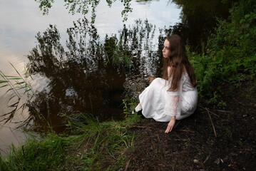Contemplation by the Water: Woman in White Dress Gazing at the Lake