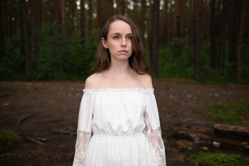 Serene Solitude: Woman in White Off-Shoulder Dress amidst Forest Tall Trees