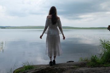 Contemplation by the Lake: Woman in White Off-Shoulder Dress, Back View