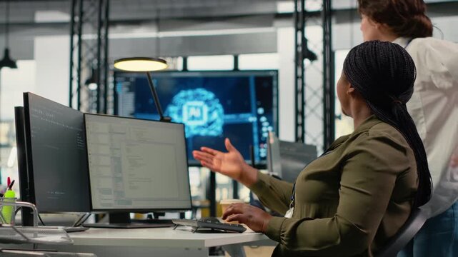 Team of technicians in office working together, automating workflows using AI. IT specialists collaborating to refine machine learning computational models for faster processing, camera B