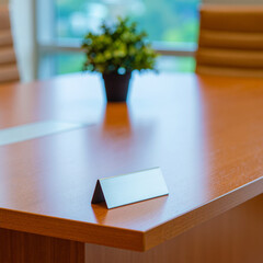 Conference room table with nameplate and plant decor for business meeting background stock photo