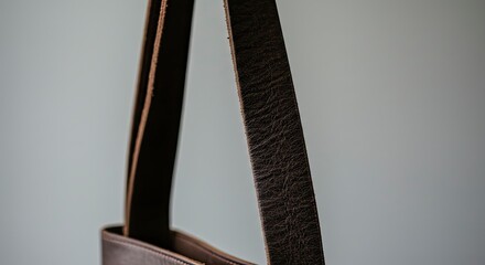 Close-up of Leather Bag Straps, Textured Brown, Minimalist Aesthetic, Neutral Background.