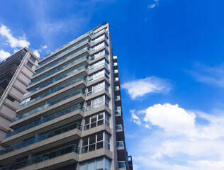 Corner modern residential house against the background of a beautiful sky with clouds.