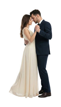 Elegant couple slow dancing with foreheads touching. Romance concept