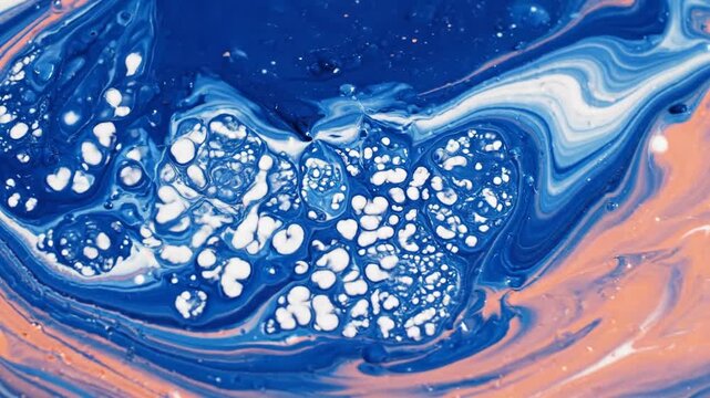 Mixing paints. Viscous swirls of blue, white, and peach create an abstract, organic pattern