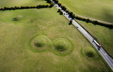Four of the prehistoric round barrow burial mounds beside A4 road on Overton Hill, Avebury, at start point of the Ridgeway National Trail. View to E