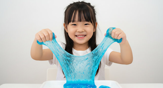 Smiling young child enthusiastically stretches bright blue slime illuminated by soft natural light for a playful moment. AI Generated
