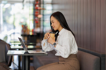 Young happy asian woman using laptop computer in coffee shop during summer, Concept of business growth finance report.