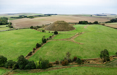 Silbury Hill prehistoric man made chalk and clay mound near Avebury stone circle henge, England. 39m high. Earliest dates from 2400BC. View from NE
