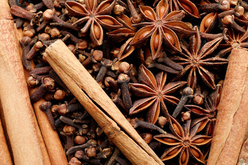 Mulled wine spices. Anise stars, cloves and cinnamon sticks as background, top view