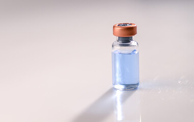 Close up of Glass Vial with Light Blue Liquid Inside