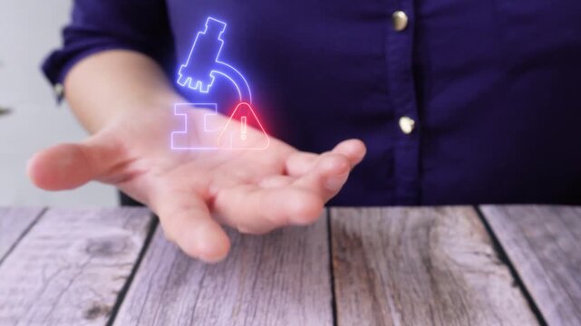 Lab results alert. Close-up of a woman's hand on a table holding a virtual microscope icon with a warning sign.