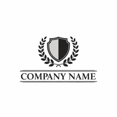 A classic black and white logo featuring a shield surrounded by laurel wreaths, with 