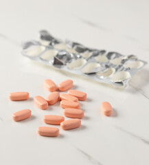 Assorted Medication Tablets and Blister Packs on White Marble Surface
