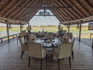 Dining table in lodge overlooking a marsh, Okavango Delta, Botswana
