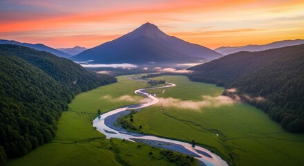 Majestic mountain range bathed in sunset glow with a winding river flowing through a lush green valley