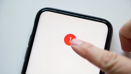 Close-up of a smartphone mock up displaying a notification alert with a red circle. A finger is gently touching the screen, emphasizing interaction with digital technology and user engagement