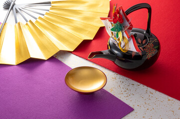 お屠蘇と扇と和風の敷物のイメージ　