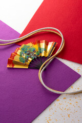 組紐と扇と和風の敷物のイメージ