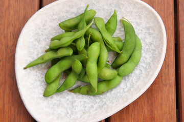Fresh edamame served on round plate