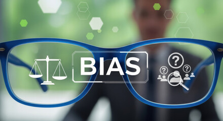 A blue eyeglasses with bias text overlay on a blurry businessman with abstract green background illustrates the concept of unfair prejudice and perspective judgment.