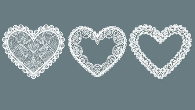 Three ornate white lace heart frames with intricate patterns on a grey background