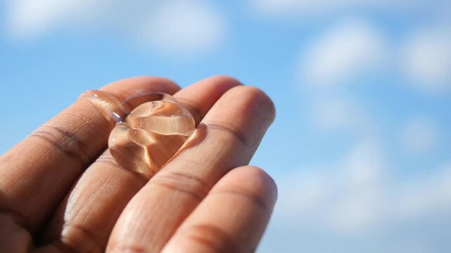 aloe vera jel on hand under blue sky