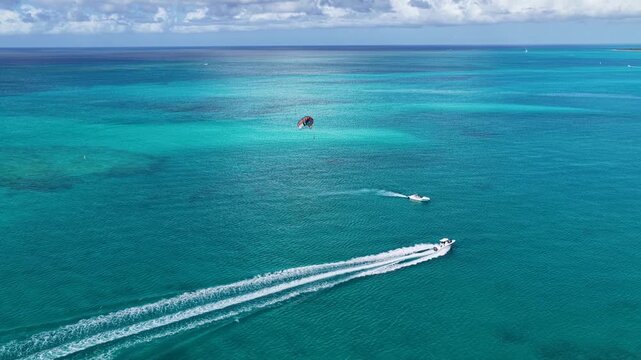 Parasailing At Providenciales In Turks And Caicos. Idyllic Beach. Nature Landscape. Aquatic Sport. Parasailing In Turks And Caicos. Aquatic Sport Landscape.